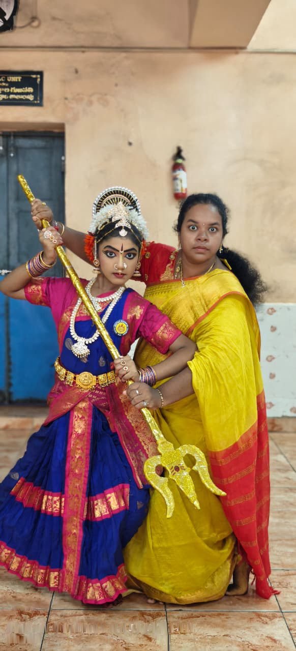 Student solo pose in pink and gold classical costume