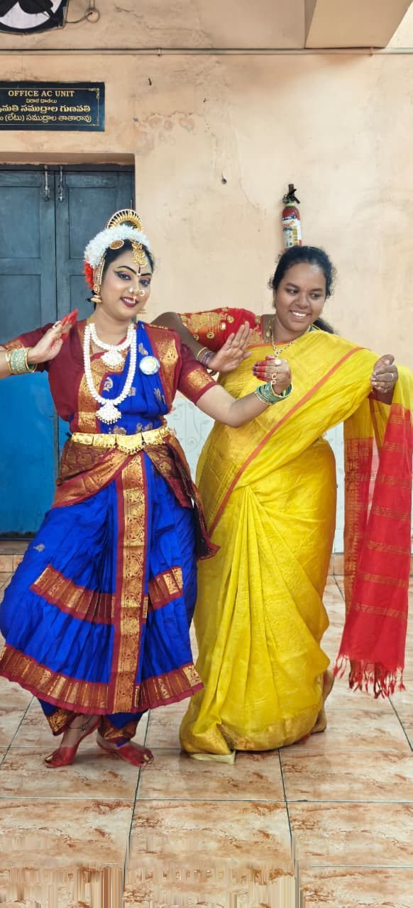 Student solo pose in purple and gold silk costume in classical pose