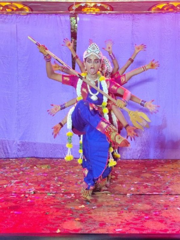 Kuchipudi dancer performing expressive Abhinaya with trident in Kali roopam
